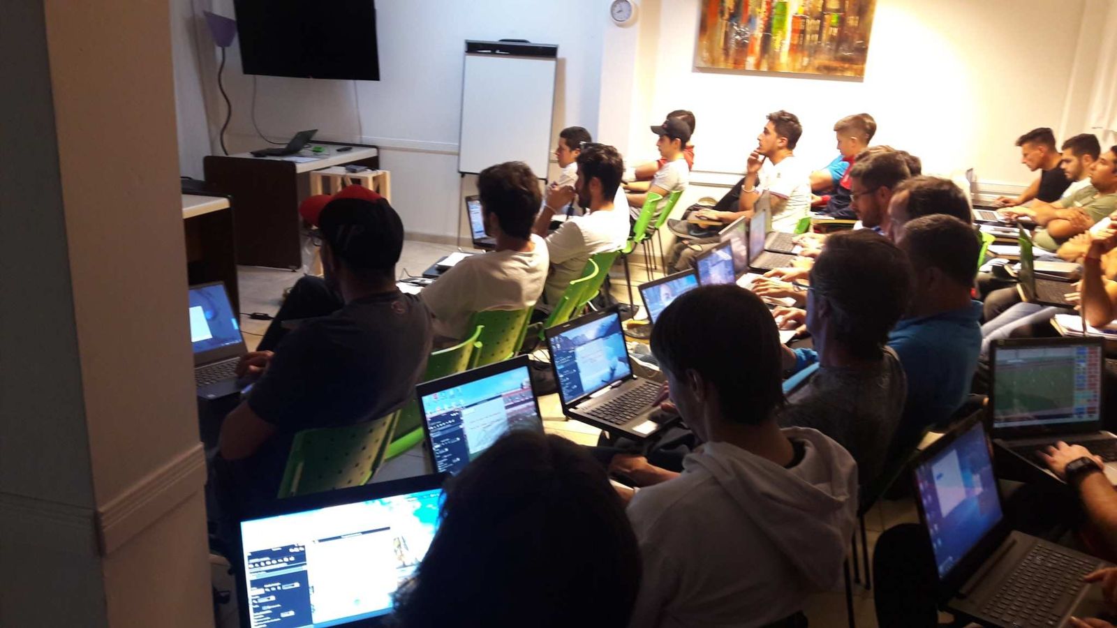 Cátedra Deportiva students using laptops during a practical football analysis class