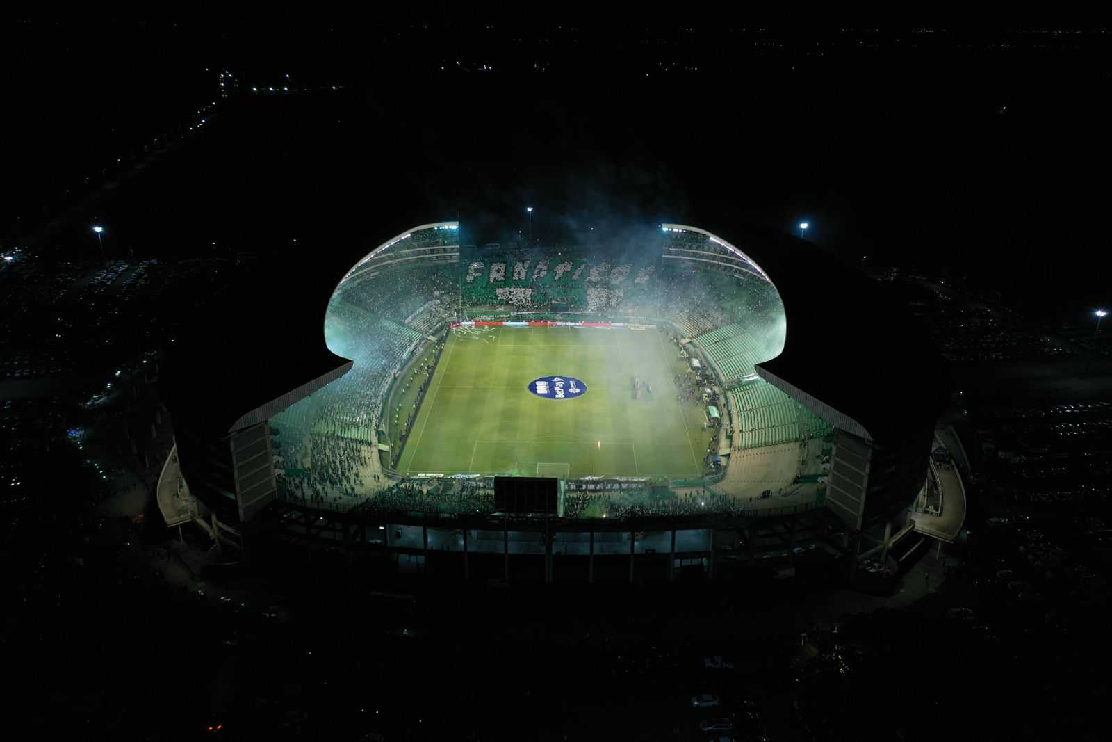 Aerial night view of Deportivo Cali's illuminated stadium and green stands