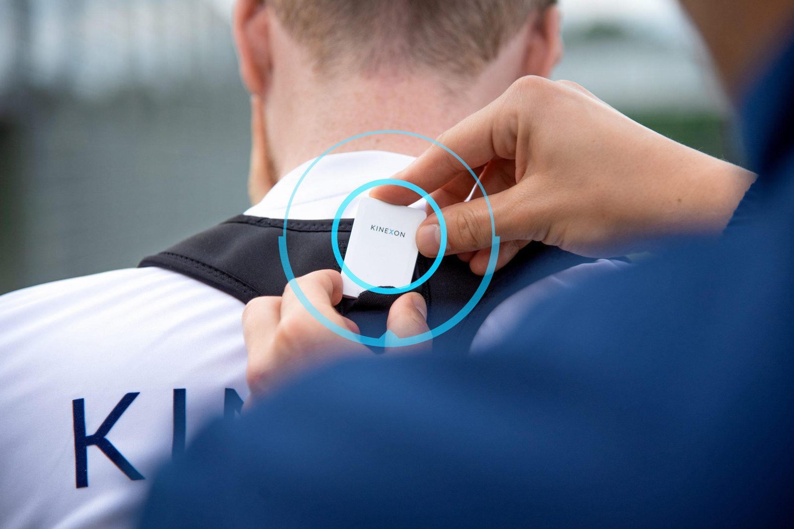 KINEXON player tracking sensor being fitted to a footballer’s vest